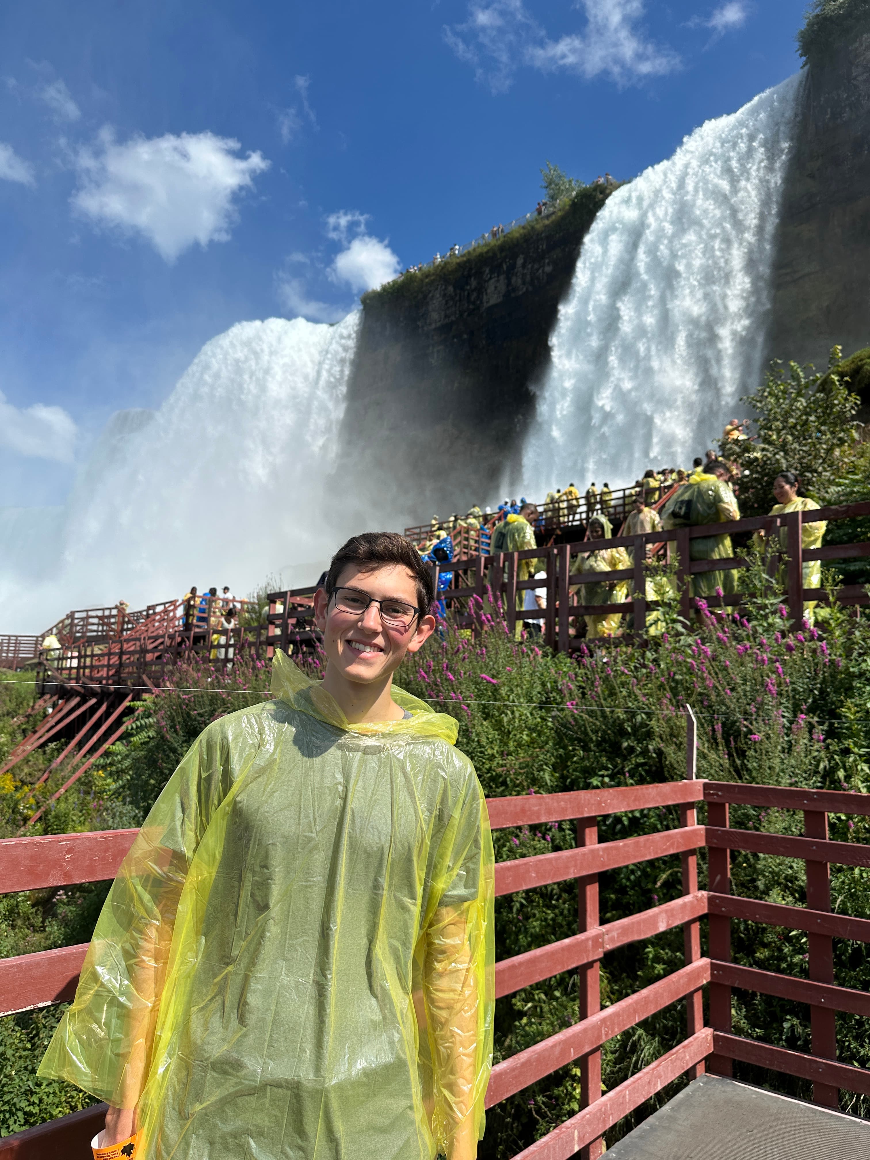 Justin standing in front of niagra falls.